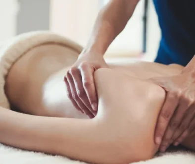 Massage being preformed on a woman's shoulder and back